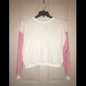 A fuzzy white and pink sweater